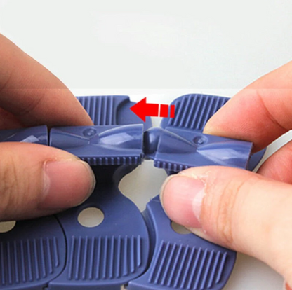 Close-up of flexible track connector clip showing snap-together mechanism for zero-gravity Changeable Track set