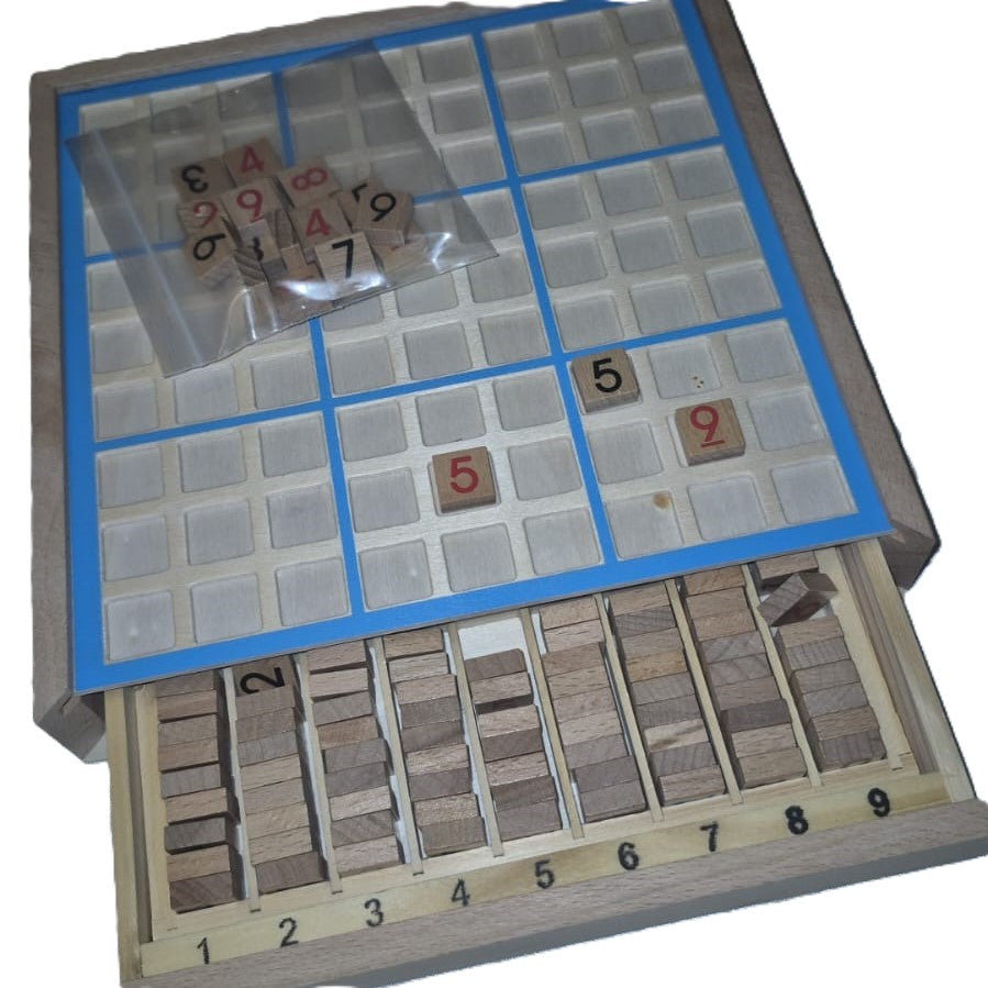 Wooden Sudoku board open with integrated drawer pulled out showing numbered wooden tiles sorted 1–9